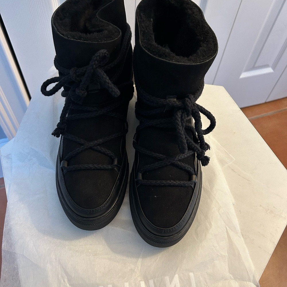 Black Inuikki boots. Size 40 European, 9 US. New with tags but no box.